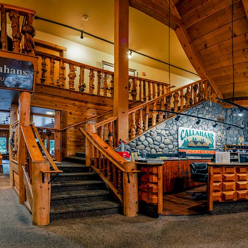 This image shows the interior of Callahan's restaurant with wooden decor, a staircase, and a reception desk. The sign says "Please wait to be seated."
