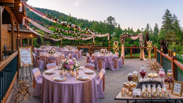 An outdoor wedding reception with round purple-draped tables, floral centerpieces, string lights, and a dessert bar under a wooden decked venue.